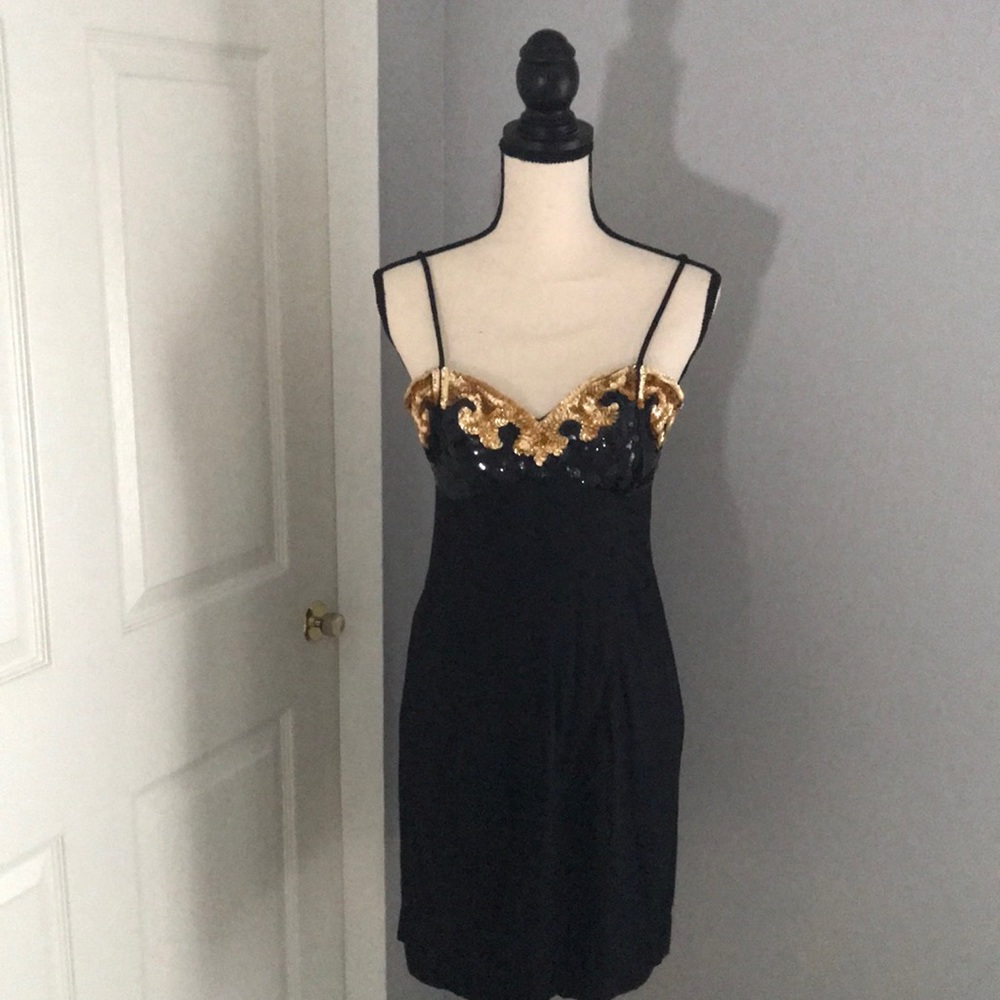 little black dress with sequence bust of gold and black.